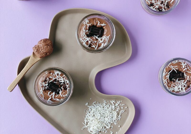 Four jars of Vegan Chocolate Pudding made with Silken Tofu, topped with coconut shavings.